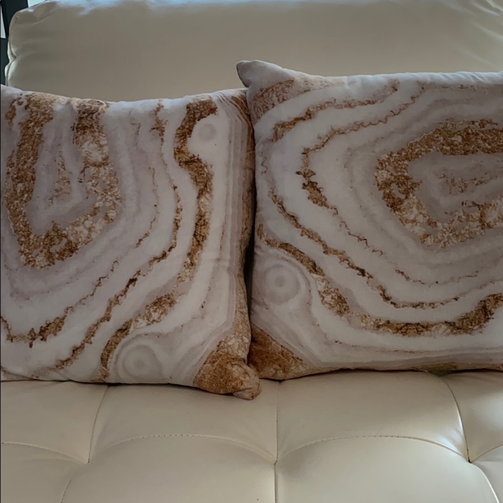 Two gold and white crystal pillows